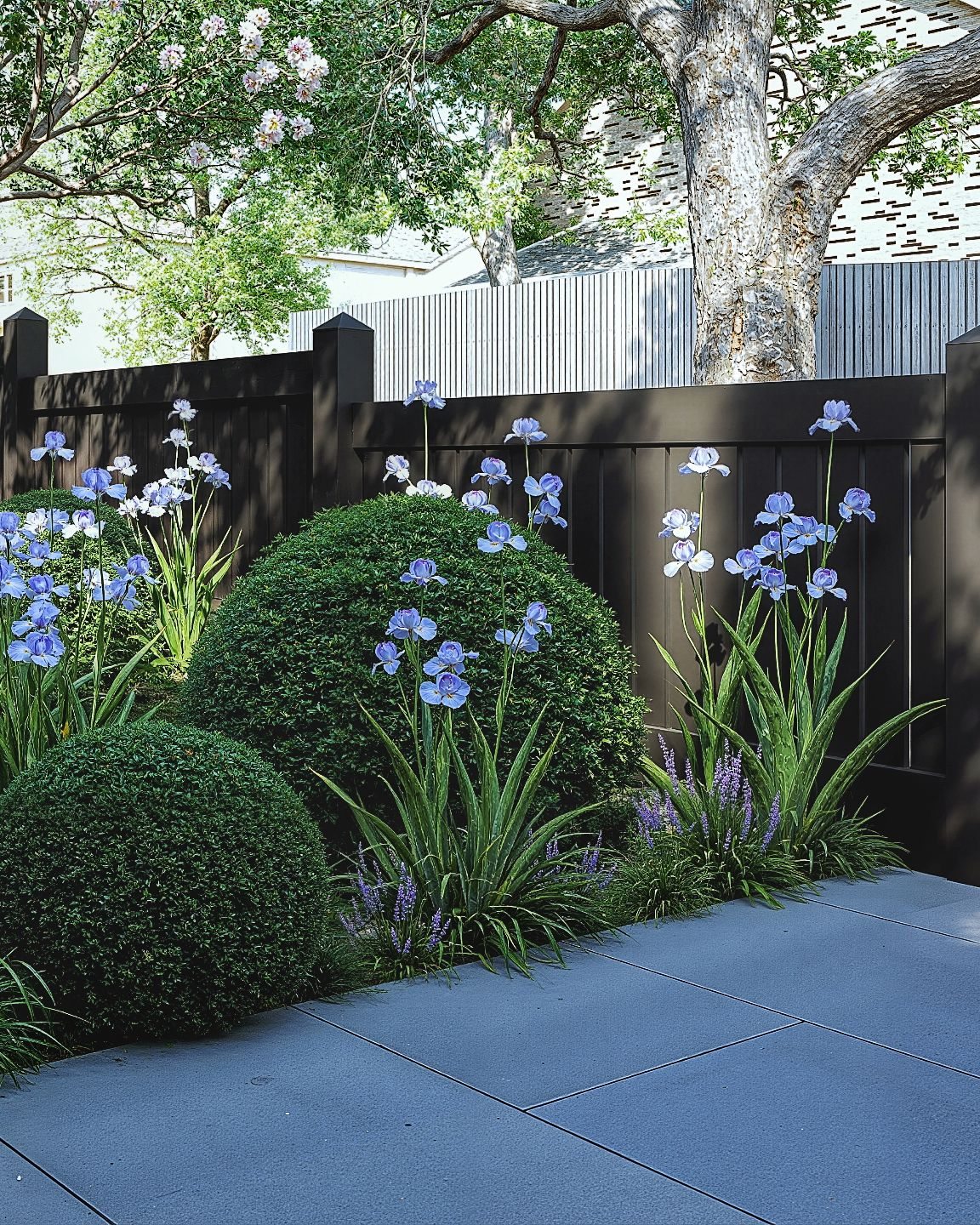 Flowering border beside a paved garden path