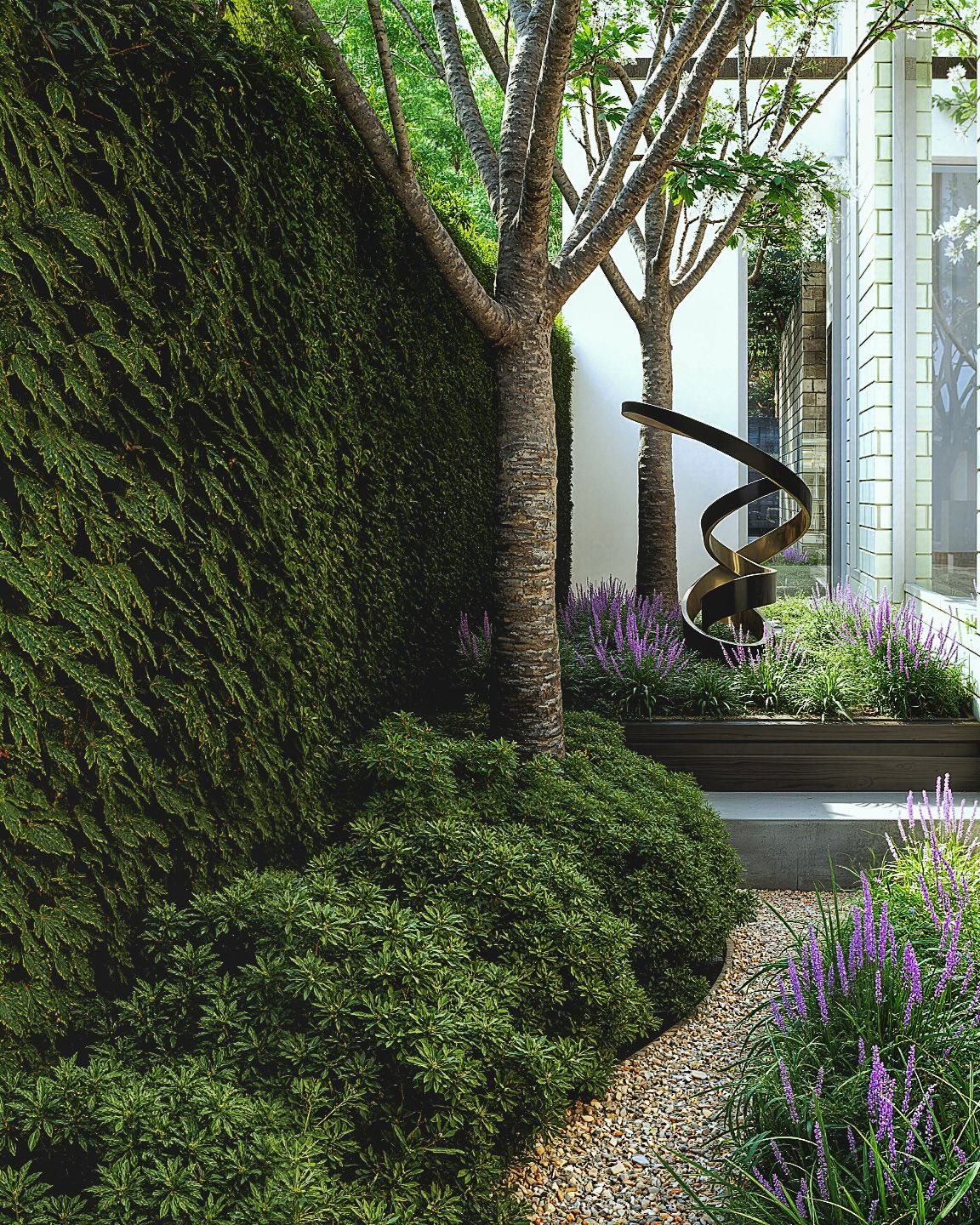 Garden court with mature trees, sculpture and flowering plants